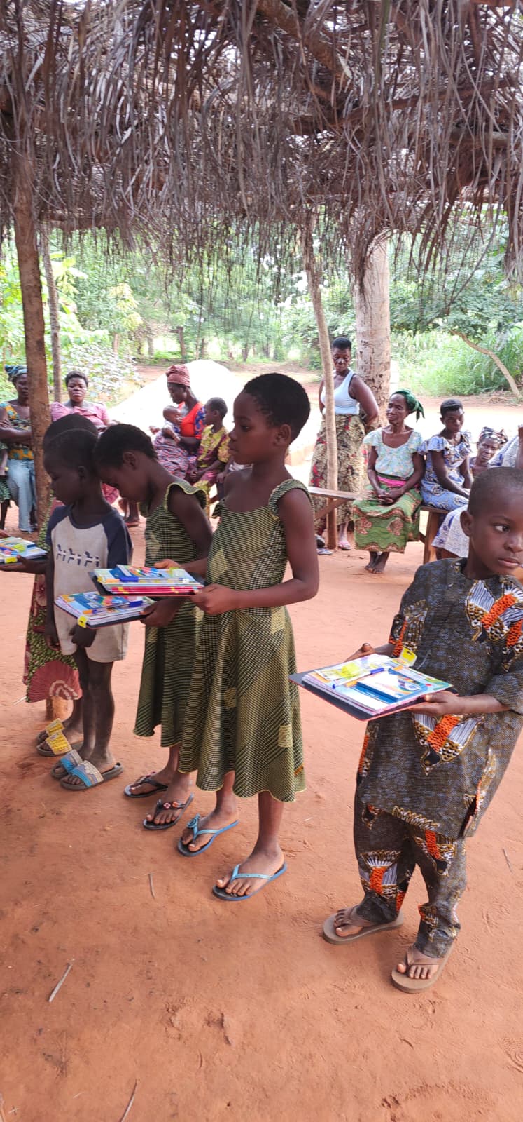 Children lined up with notebooks during the ASTO-VMDC school supply distribution