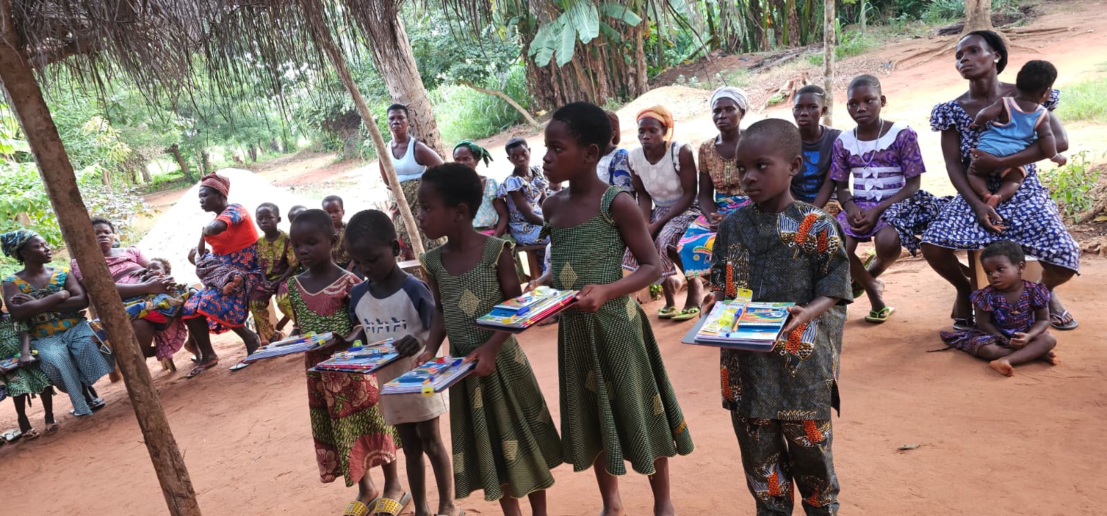 Mothers and children gathered as kids receive school supplies from ASTO-VMDC